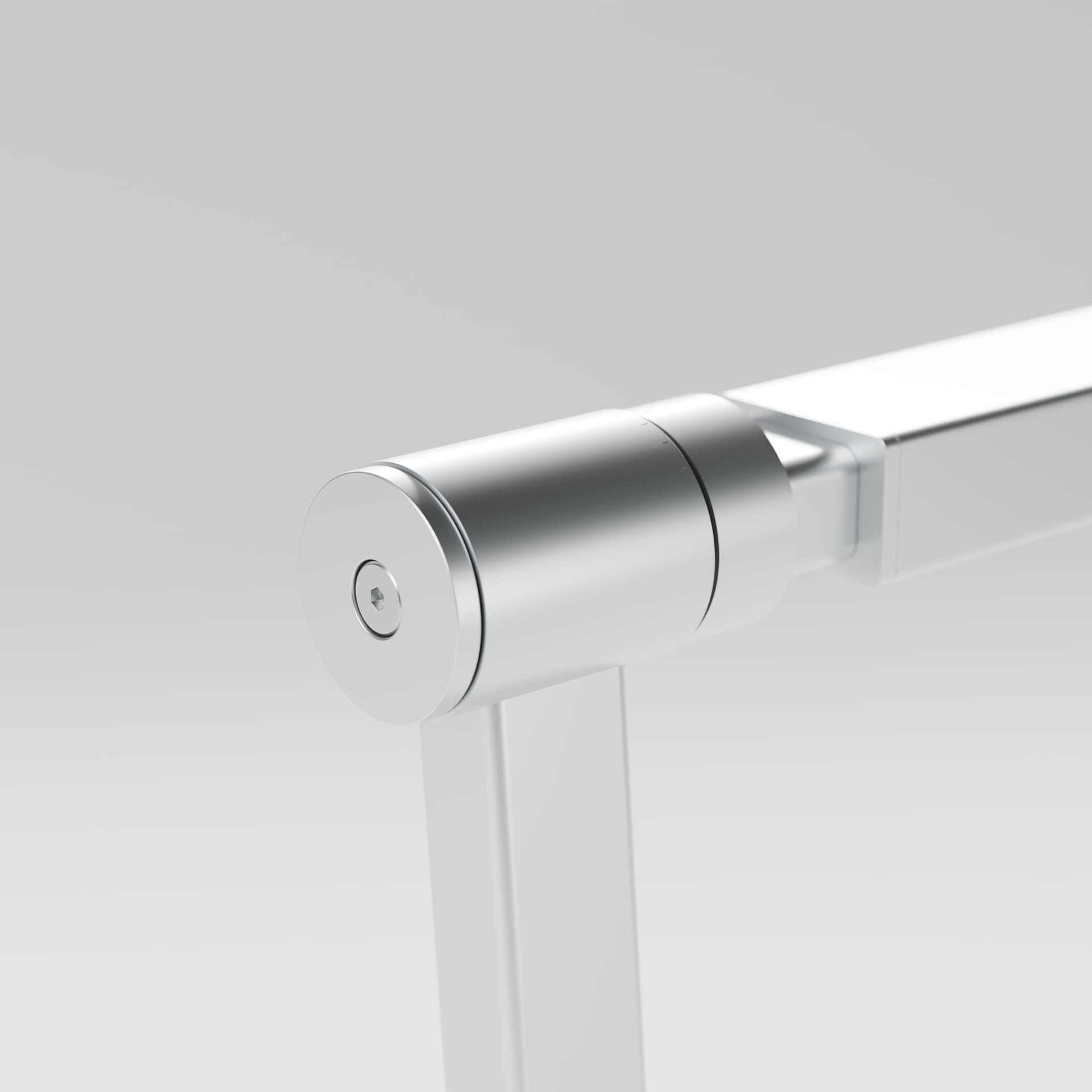 Close view of the hinge: a machined aluminum cylinder with a recessed hex-socket cap screw, joining the vertical support to the horizontal head.